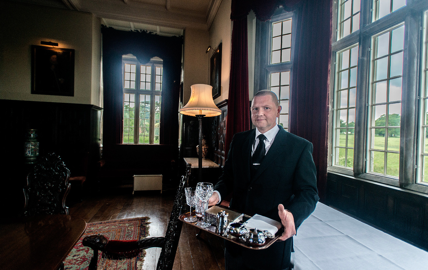 a man in a suit holding a tray of food