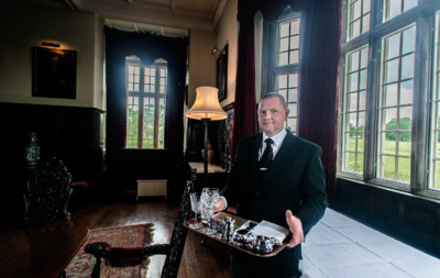 a man in a suit holding a tray of food