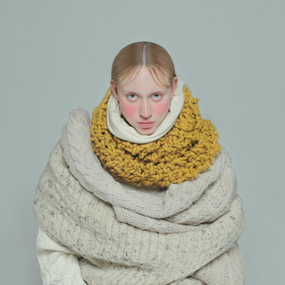 a woman wrapped in a yellow and white blanket