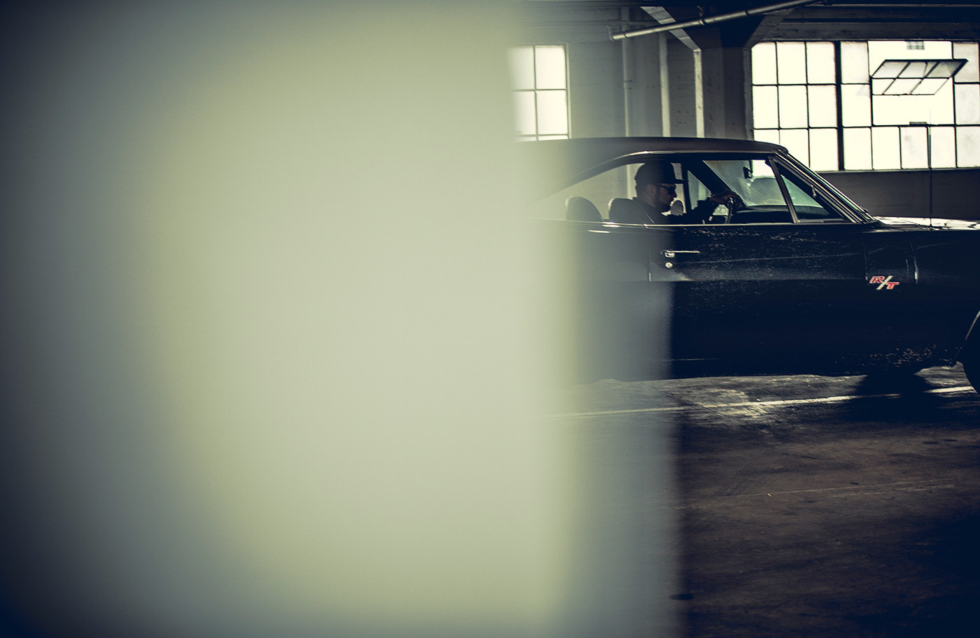 a black car parked in a garage next to a window