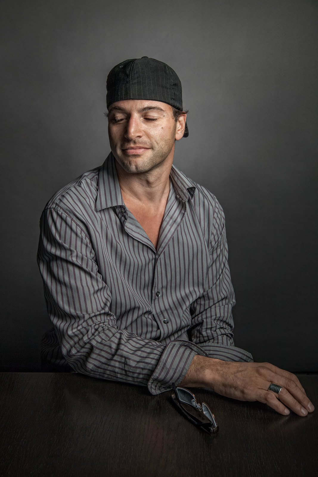 a man sitting at a table with his eyes closed