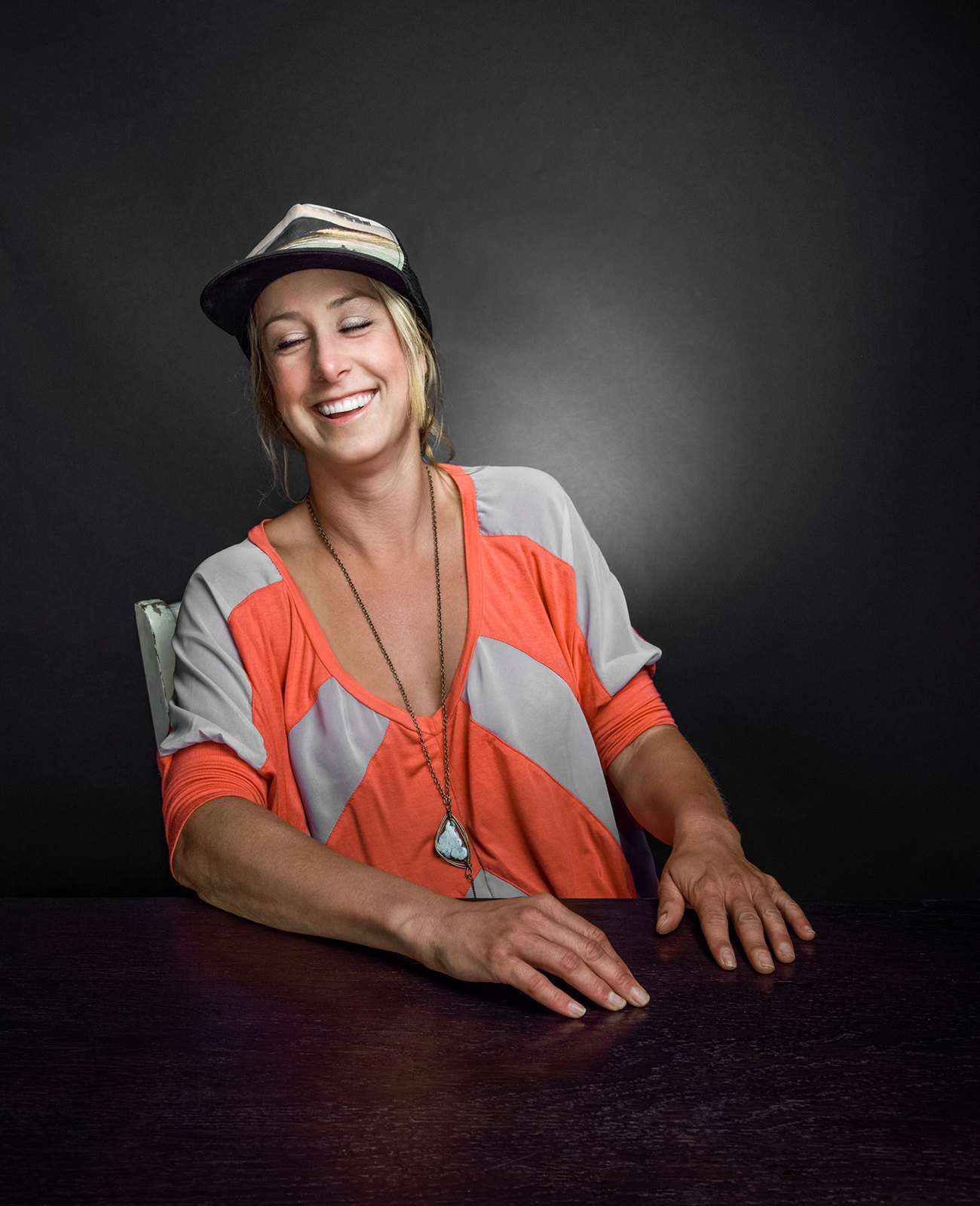 a woman sitting at a table with her eyes closed