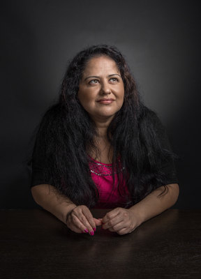 a woman with long hair sitting at a table