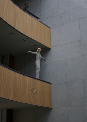 a woman standing on the balcony of a building