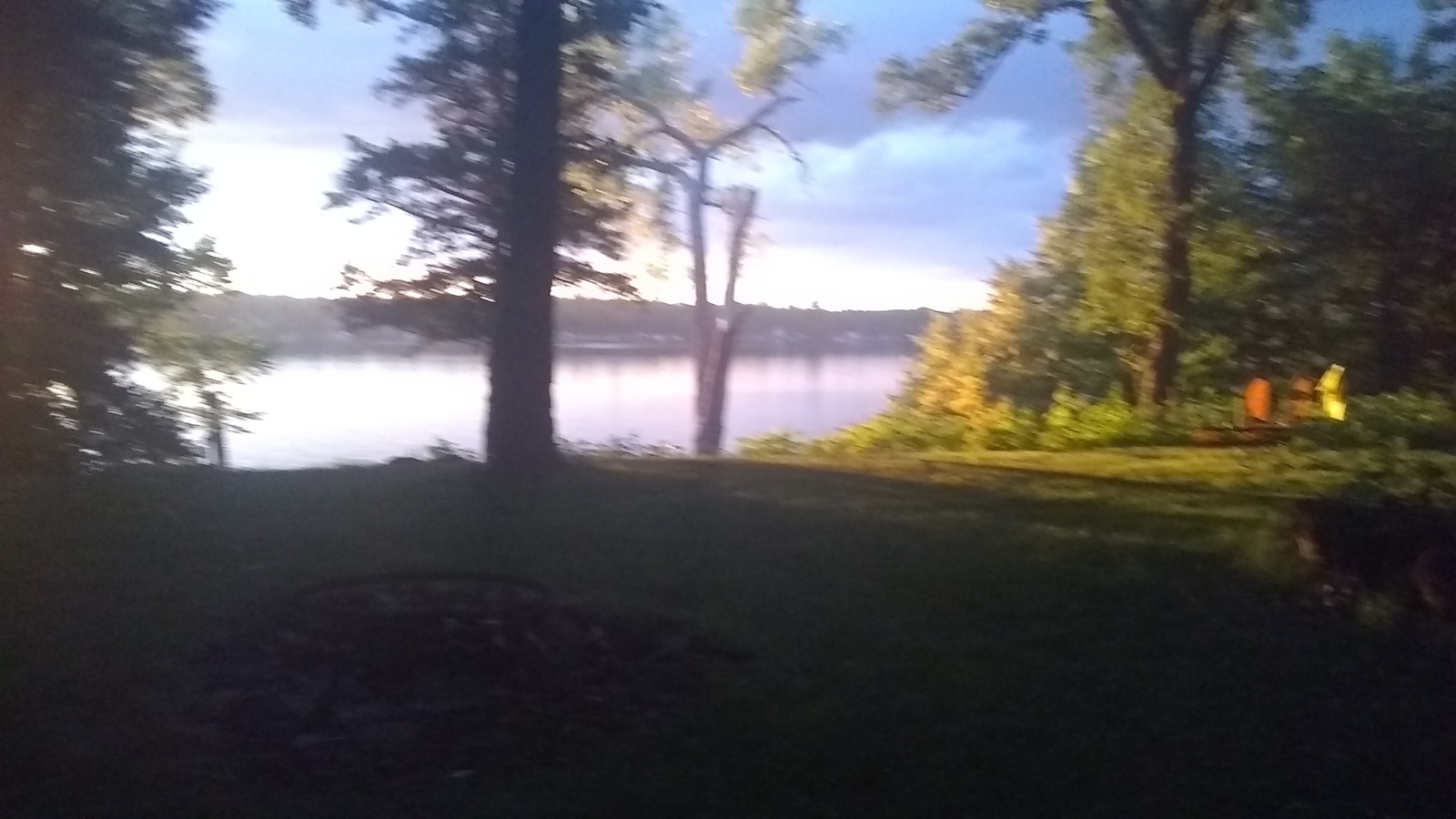 a view of a lake through some trees