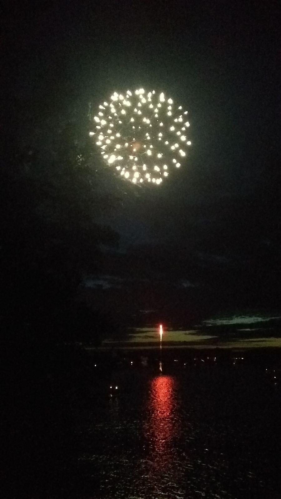 a fireworks is lit up in the night sky