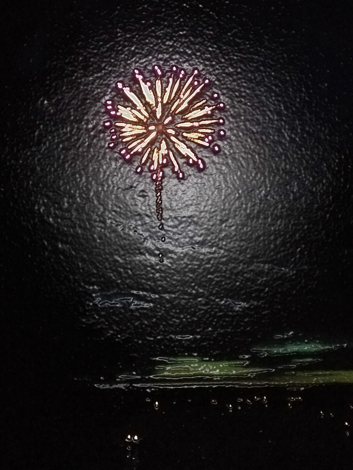 a firework in the middle of a dark room