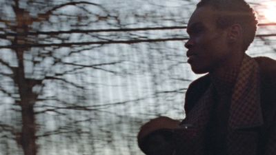 a man standing in front of a window holding a cell phone