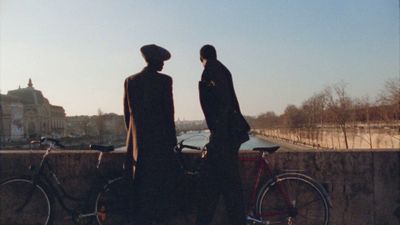 a couple of people standing next to a bike