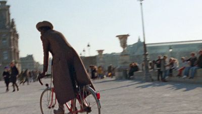 a man riding a bike down a street