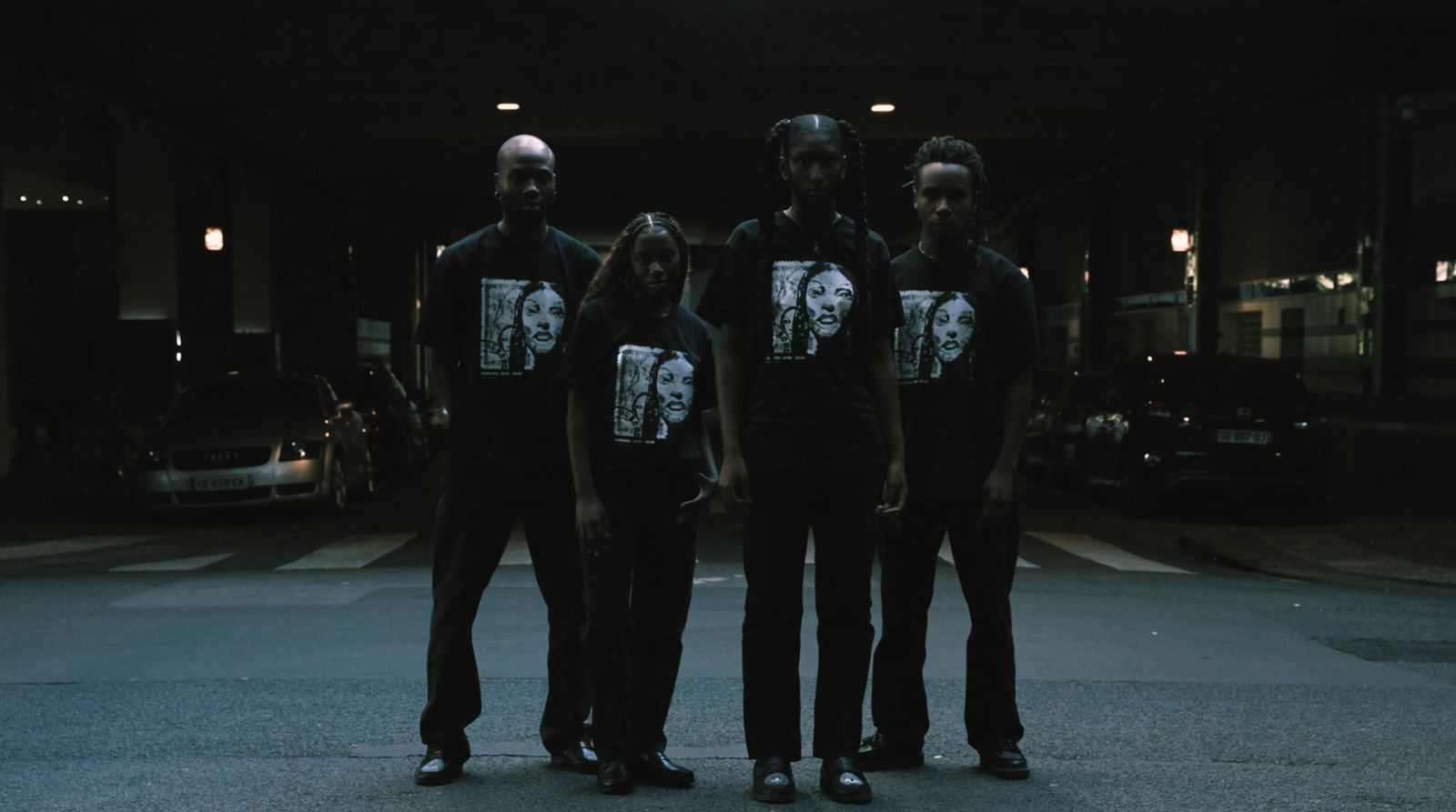 a group of people standing in the middle of a street