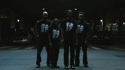 a group of people standing in the middle of a street