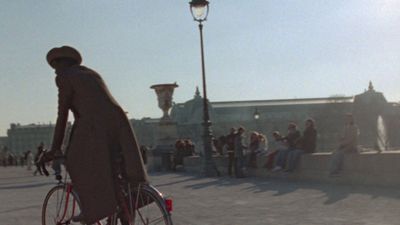 a woman riding a bike down a street