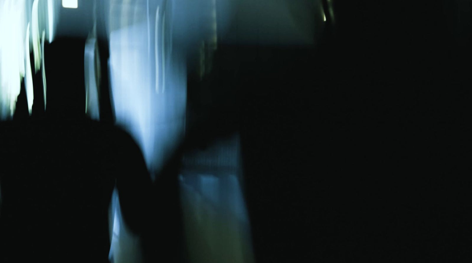 a blurry photo of a person walking in the dark