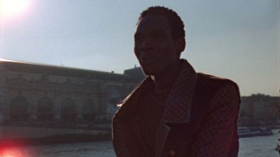 a man standing in front of a body of water