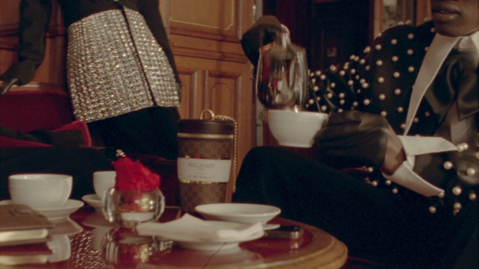 a man sitting in a chair holding a cup of coffee