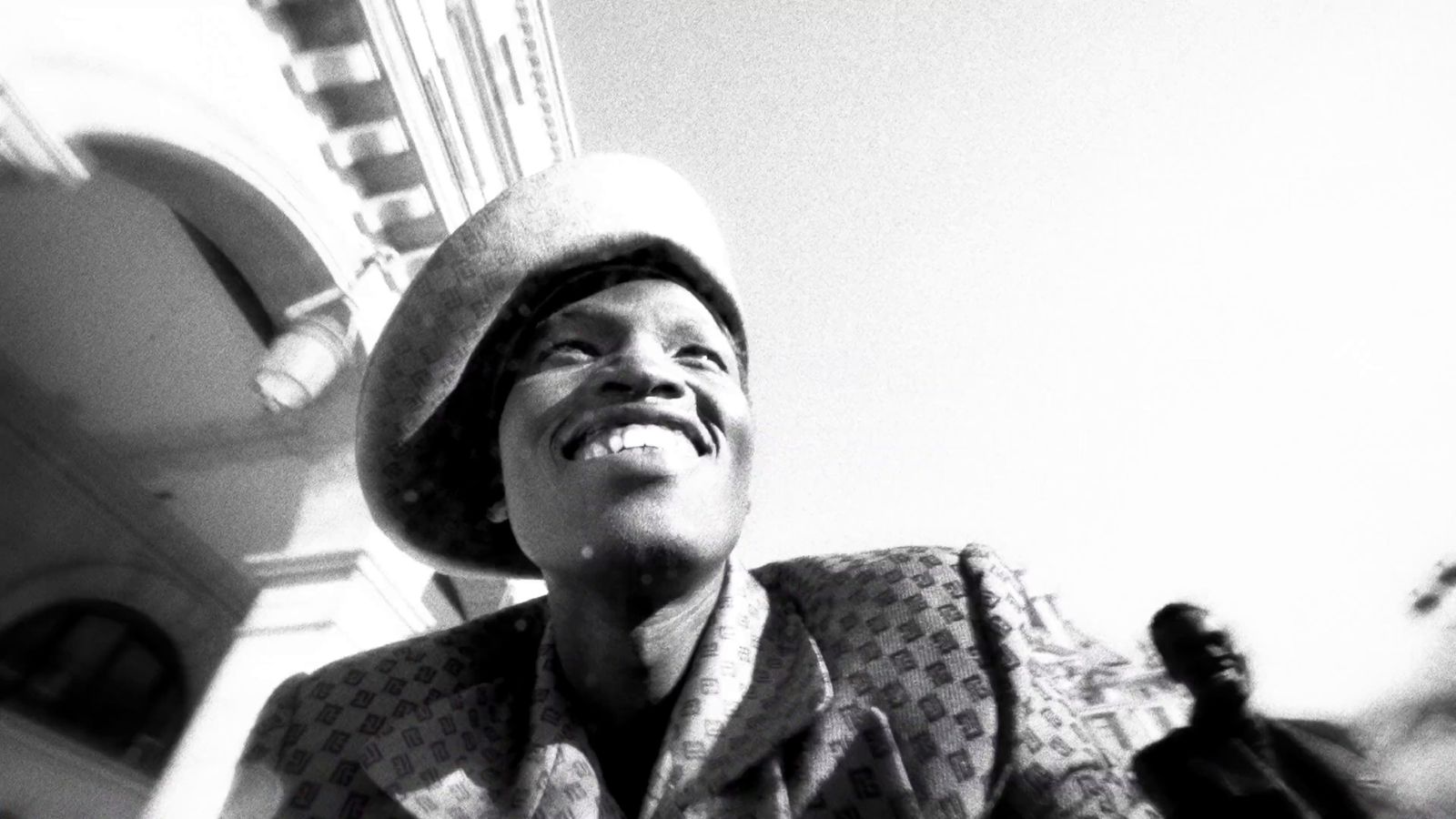 a black and white photo of a woman wearing a hat