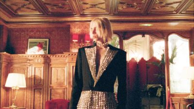 a woman in a black and white dress standing in a room