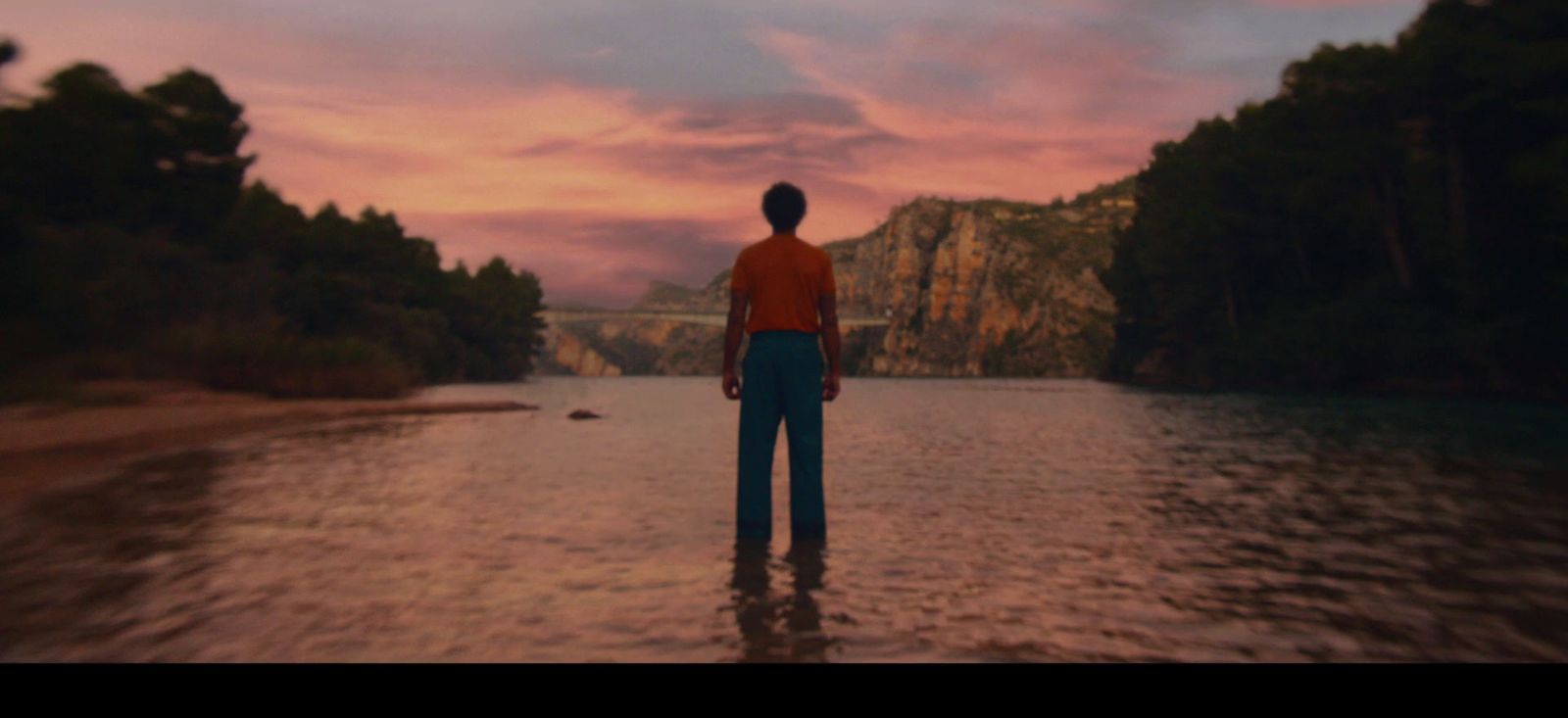 a man standing in the middle of a body of water