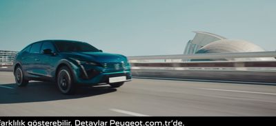 a blue suv driving down a highway next to a bridge