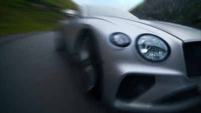 a blurry photo of a car driving down a road