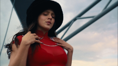 a woman in a red dress and a black hat