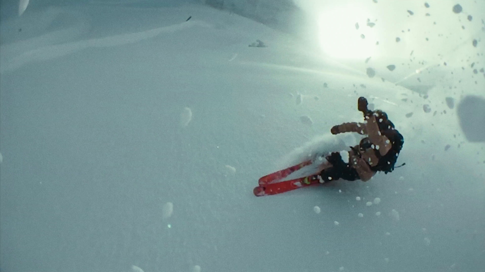 a person riding skis down a snow covered slope