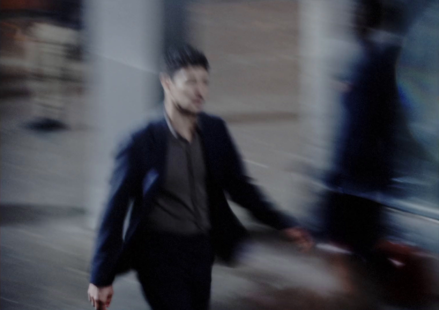 a blurry photo of a man walking down the street