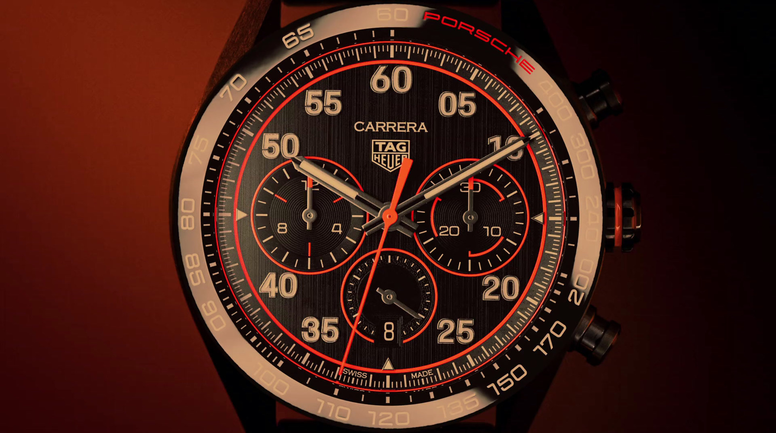 a close up of a watch on a red background