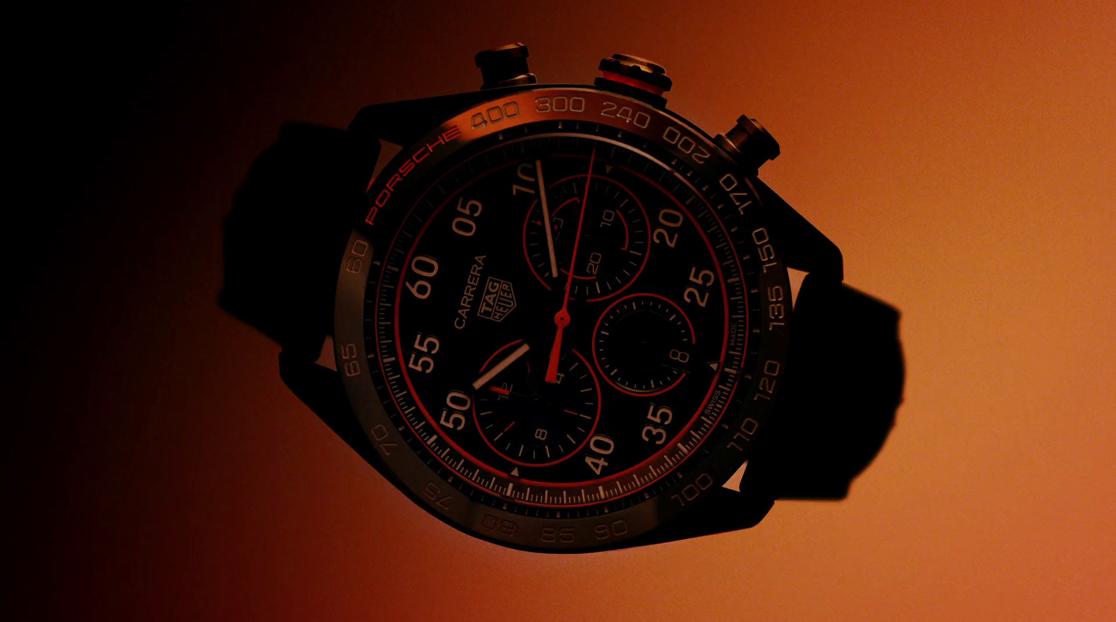 a close up of a watch with a red and black face