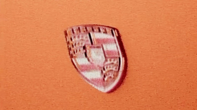 a close up of a car emblem on an orange background