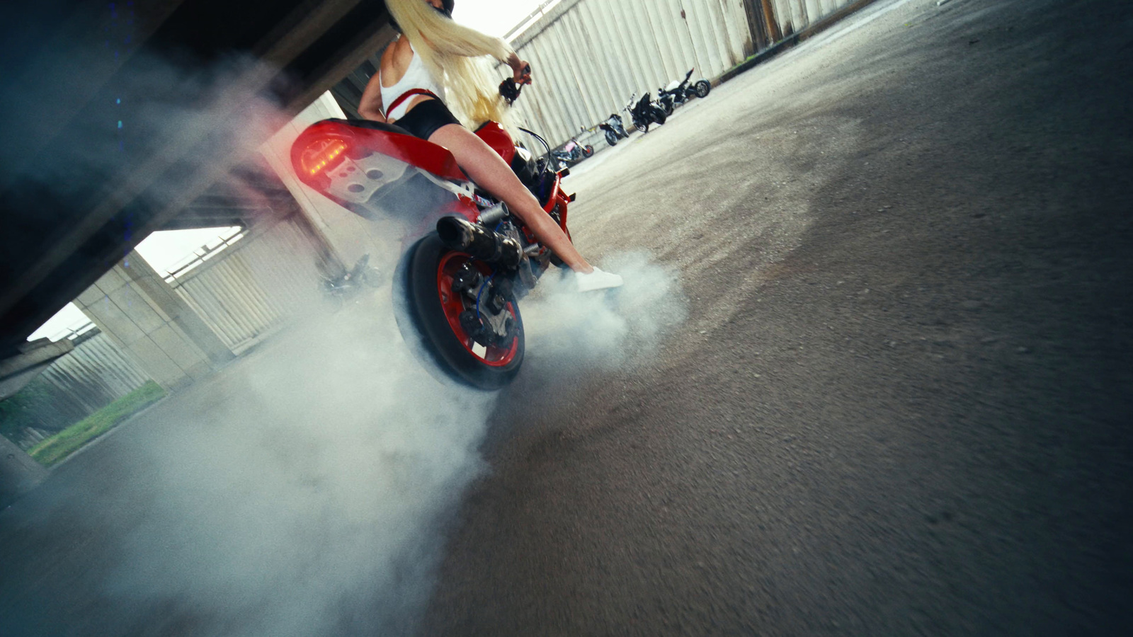 a woman riding on the back of a red motorcycle