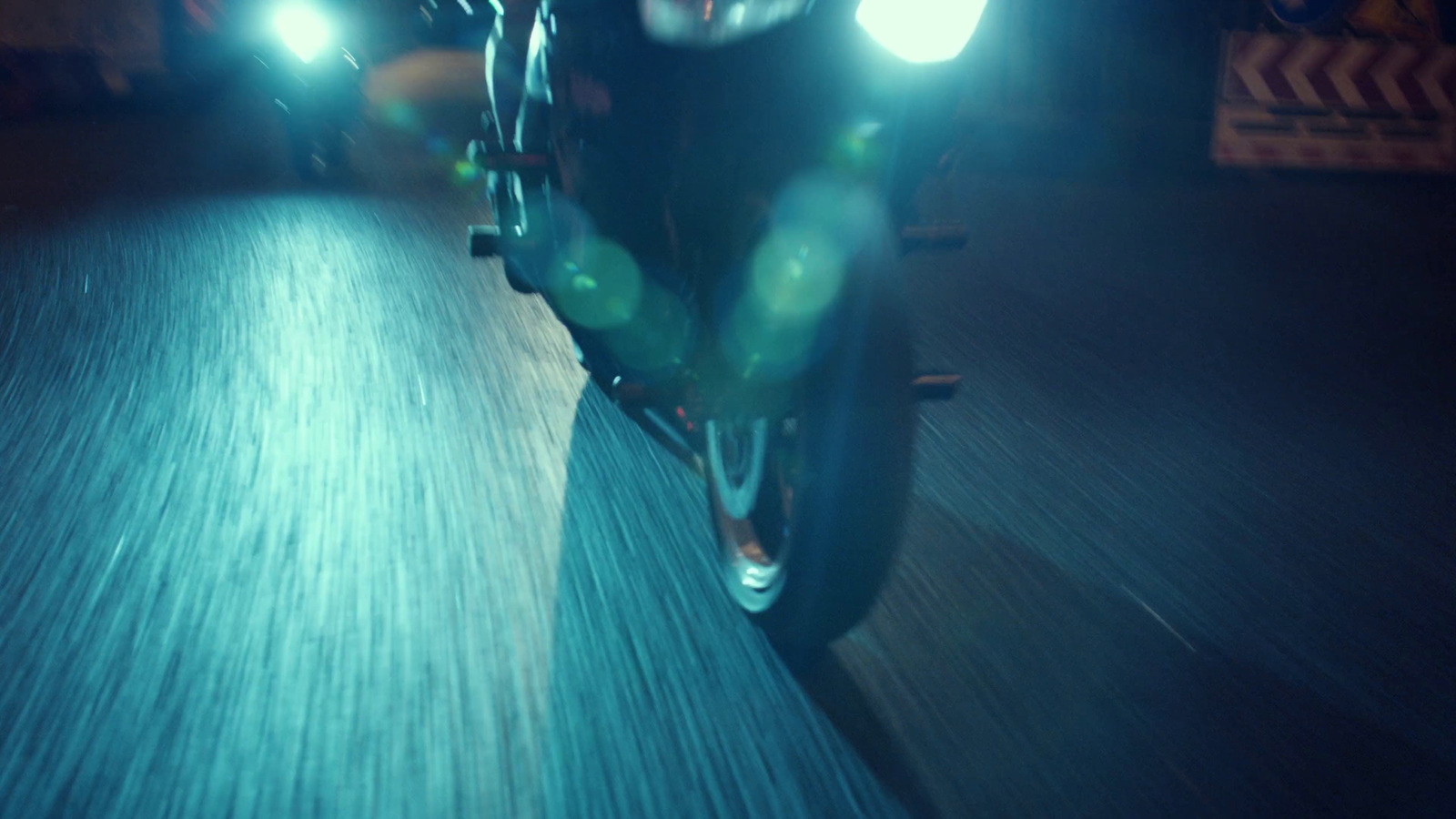 a person riding a motorcycle in the dark