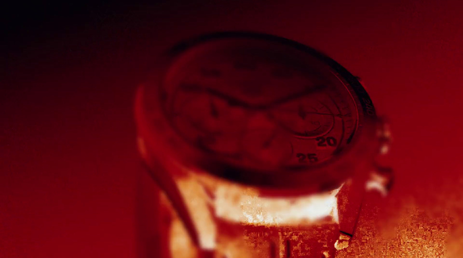 a close up of a clock on a red background