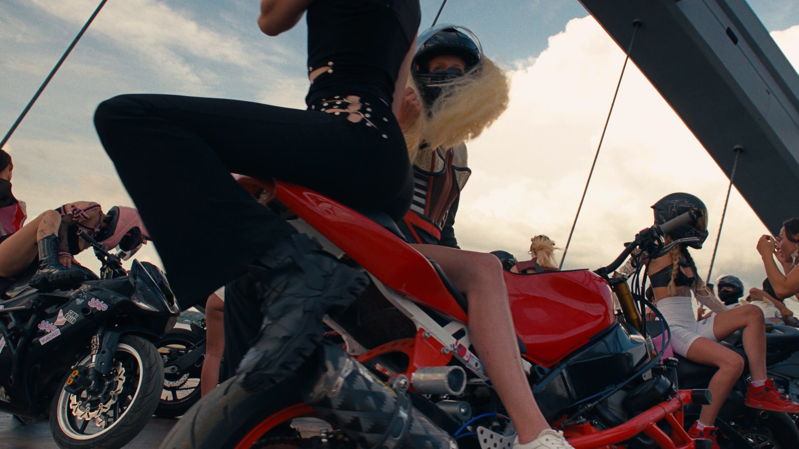 a woman sitting on top of a red motorcycle