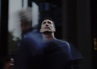 a man standing in front of a tall building