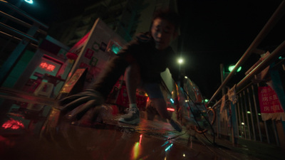 a man riding a skateboard down a street at night