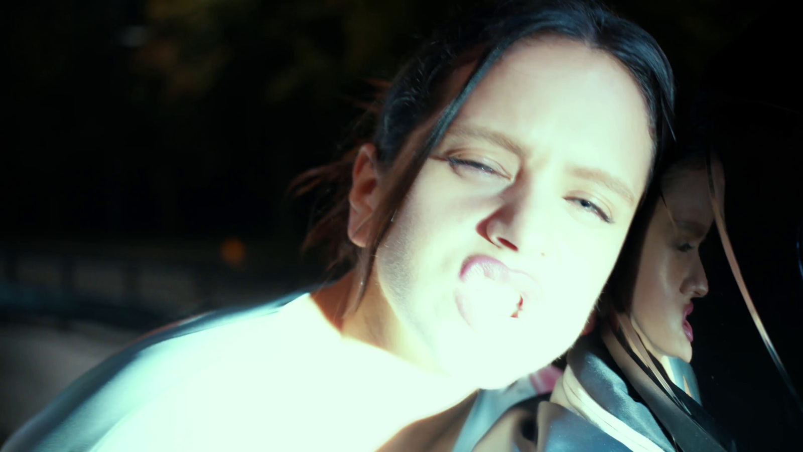 a woman sticking her tongue out of a car window