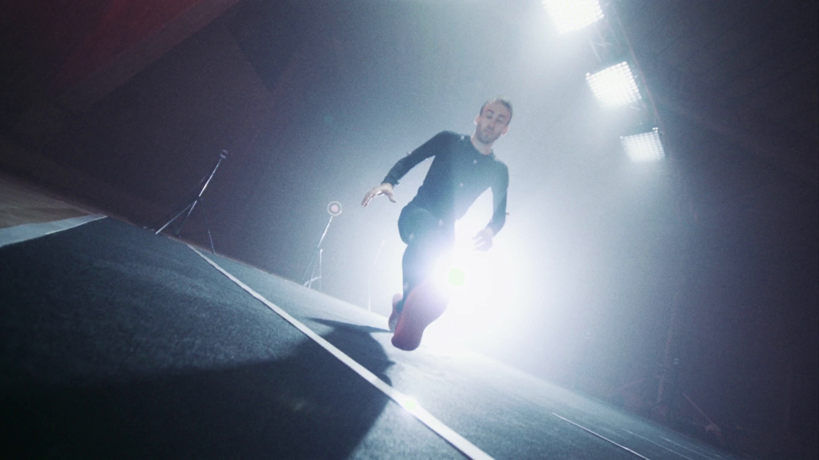 a man is running on a runway in the dark