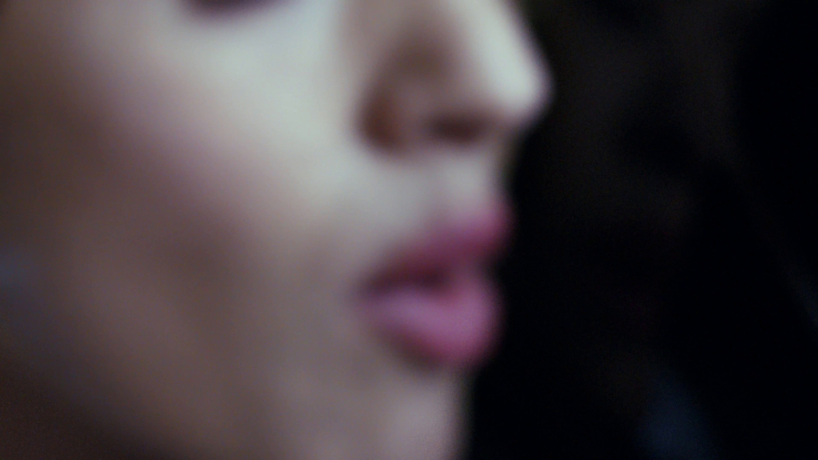 a close up of a person's face with a blurry background