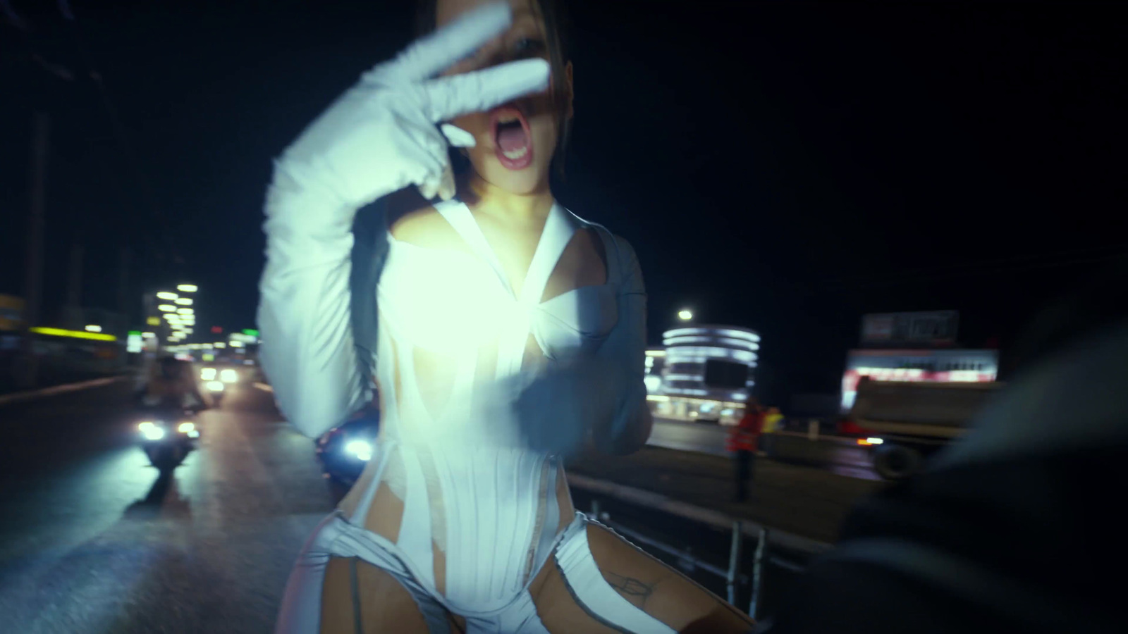 a woman in a white bodysuit is dancing on the street