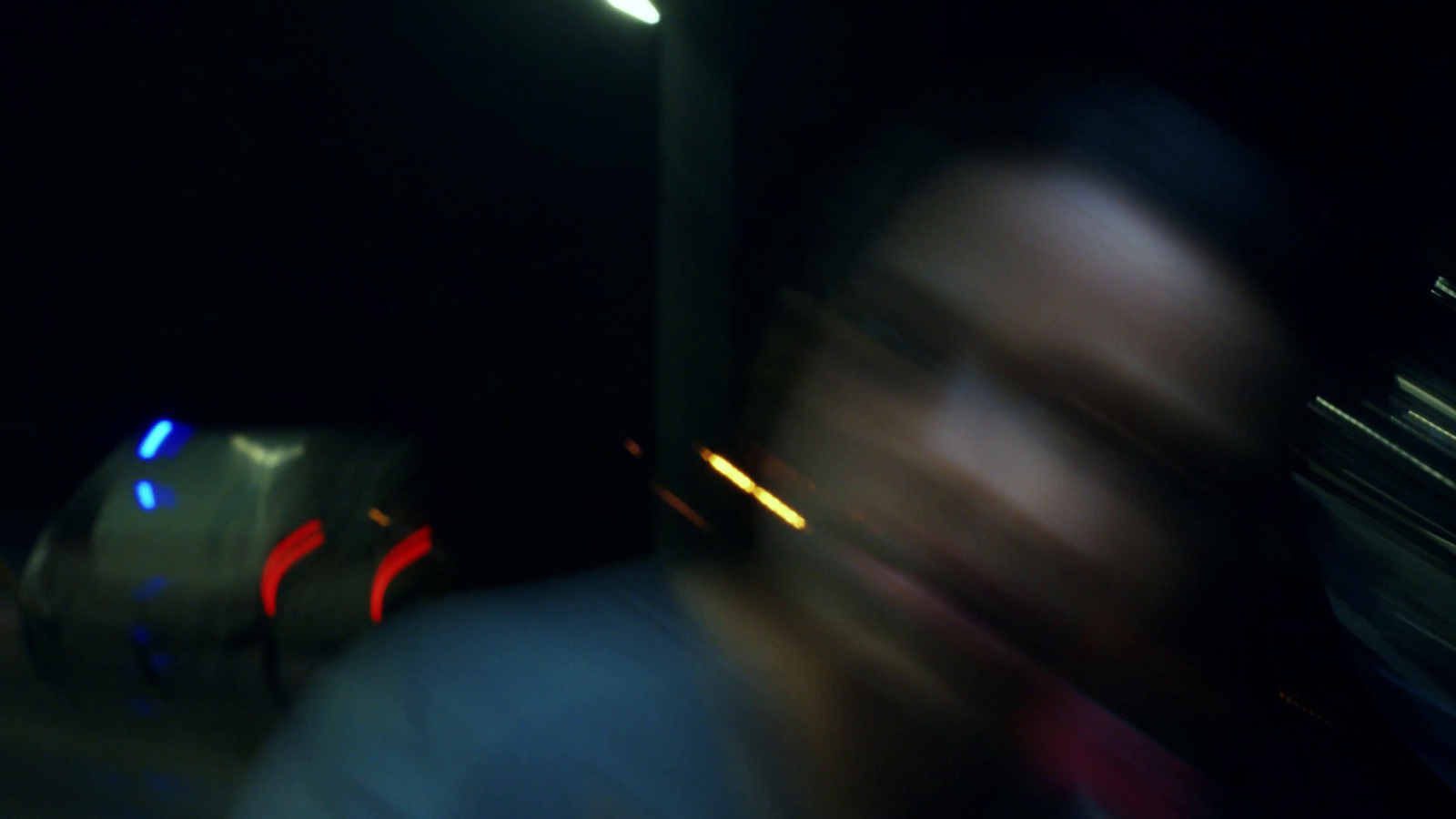 a blurry photo of a person on a bus at night