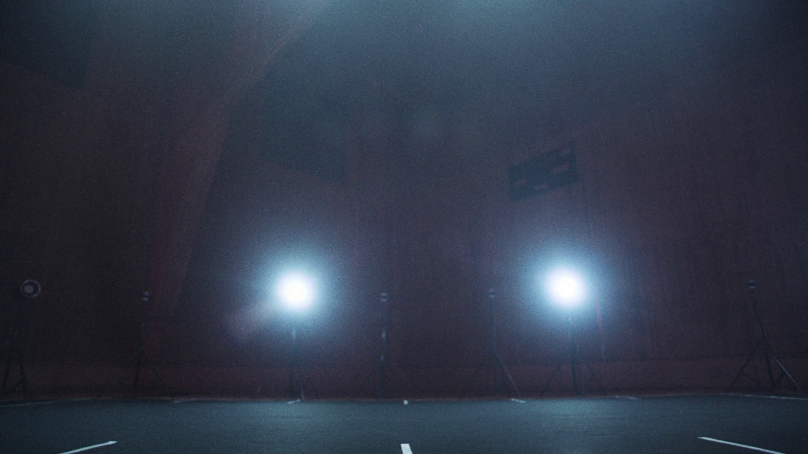 a tennis court with three lights on it