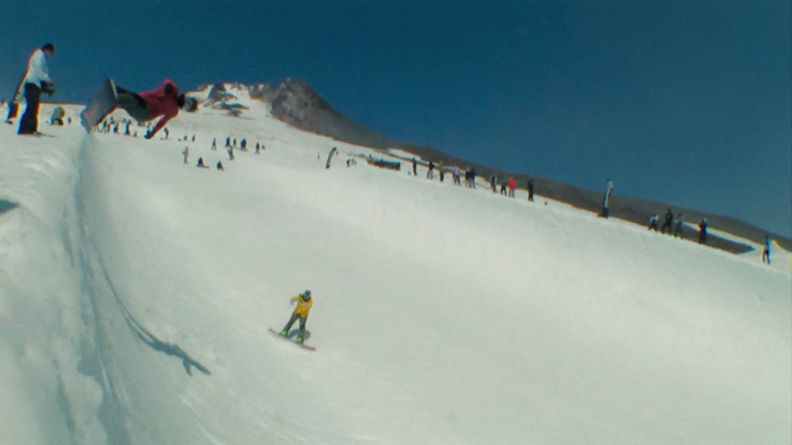 a group of people riding skis down a snow covered slope