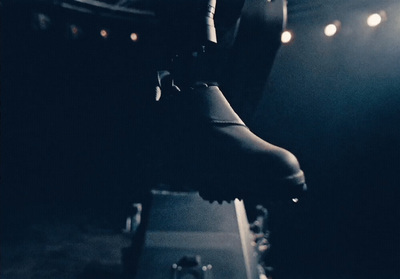 a black and white photo of a pair of shoes on a stage