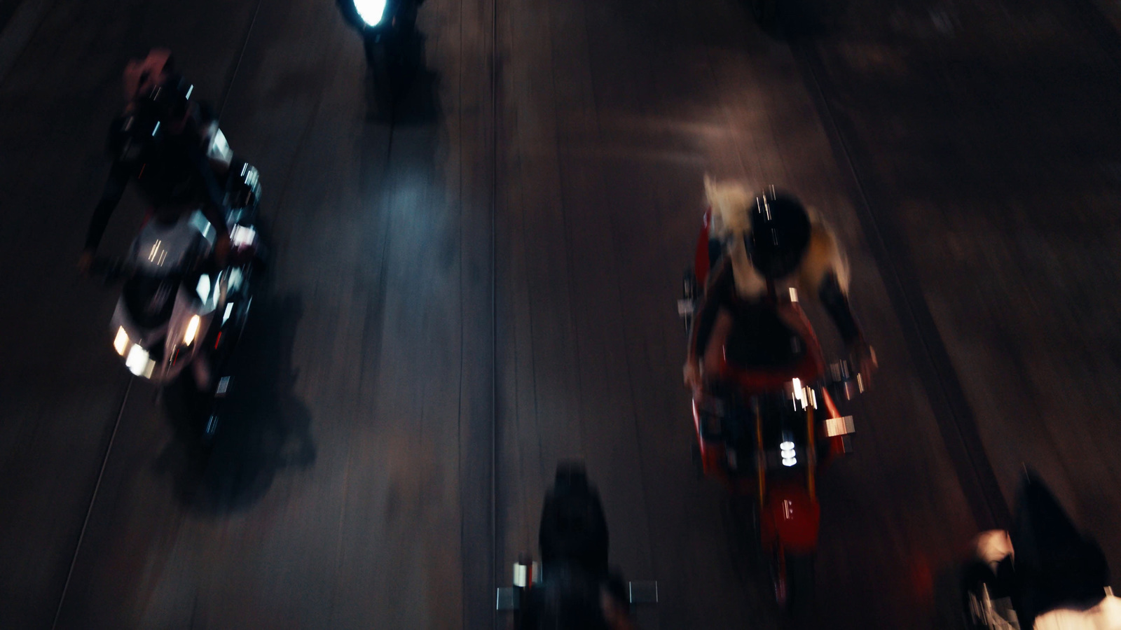 a group of people riding motorcycles down a street