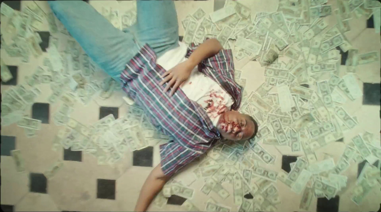 a person laying on a bed covered in money