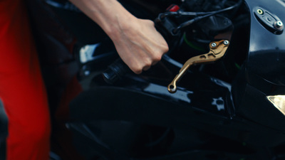 a close up of a person's hand on a motorcycle