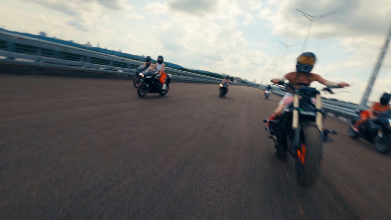 a group of people riding motorcycles down a street