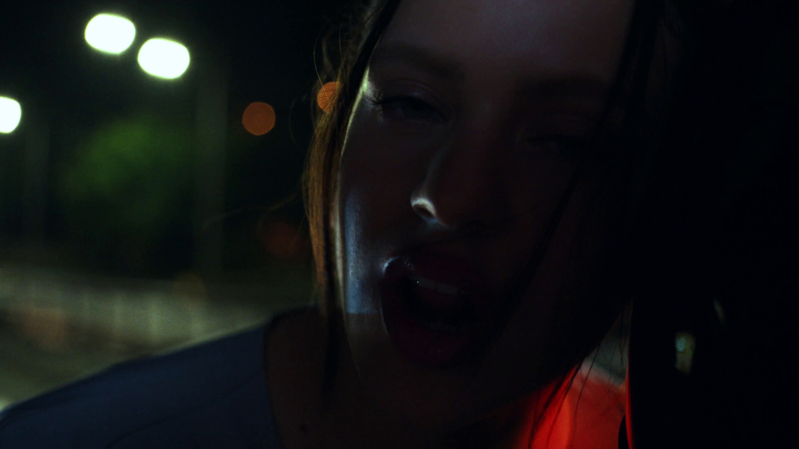 a woman with her mouth open in the dark